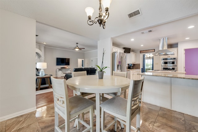 dining room with ceiling fan with notable chandelier