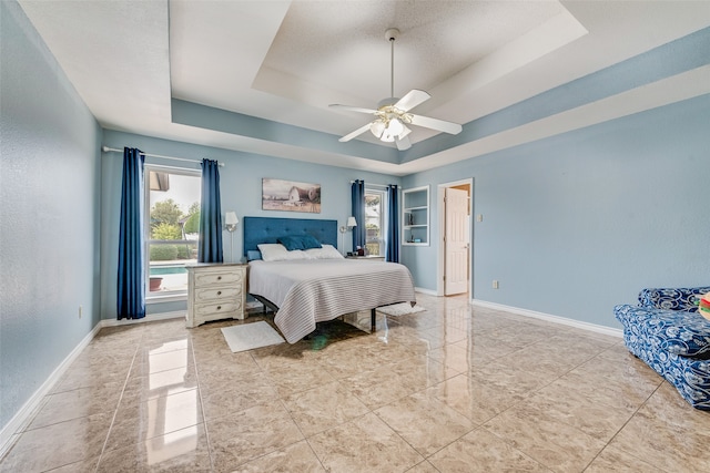 bedroom featuring a tray ceiling and ceiling fan