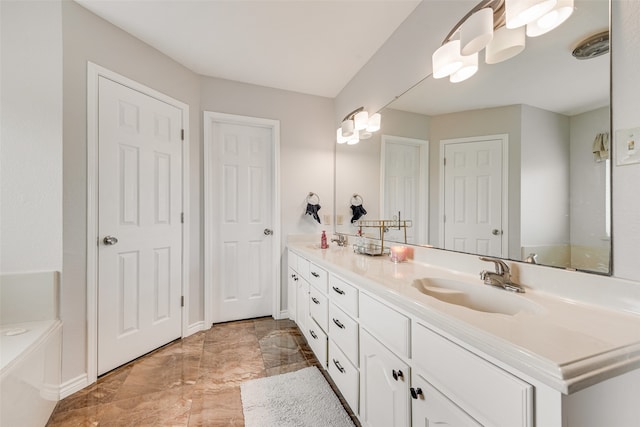 bathroom with a washtub and vanity