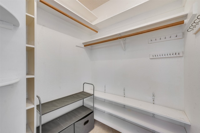 spacious closet featuring light tile patterned floors