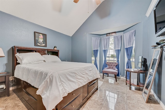 bedroom with ceiling fan and high vaulted ceiling