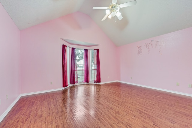 spare room with a textured ceiling, high vaulted ceiling, ceiling fan, and hardwood / wood-style flooring