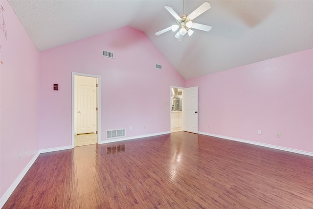 unfurnished room with ceiling fan, a textured ceiling, dark hardwood / wood-style flooring, and high vaulted ceiling