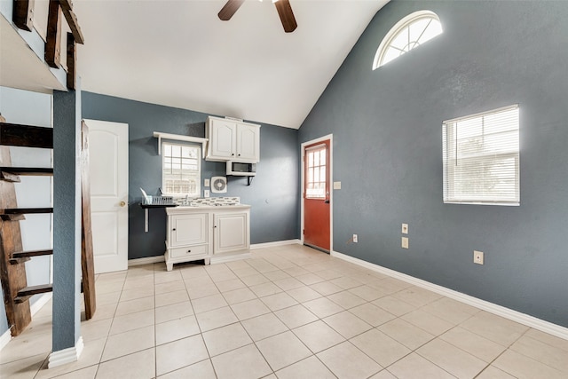 kitchen with white cabinets, lofted ceiling, ceiling fan, and plenty of natural light