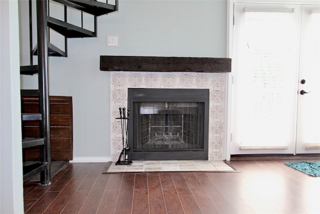 room details featuring hardwood / wood-style flooring and a tiled fireplace