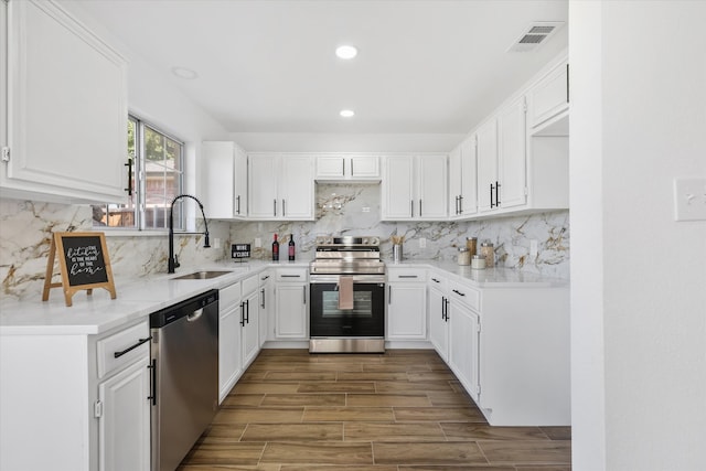 kitchen with white cabinetry, stainless steel appliances, and sink