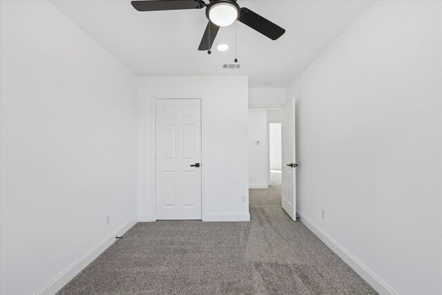 unfurnished bedroom featuring ceiling fan and carpet flooring