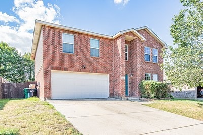 front of property featuring a garage and a front lawn