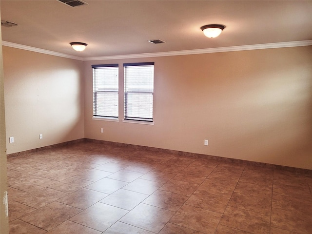 spare room featuring crown molding