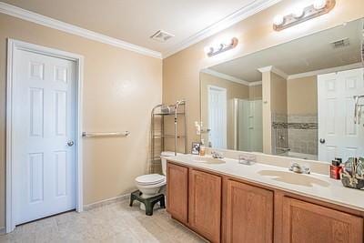 bathroom featuring tile patterned flooring, toilet, vanity, and ornamental molding