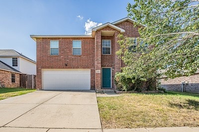 view of property with a front yard and a garage