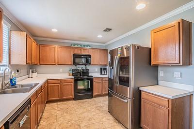 kitchen with black appliances, a healthy amount of sunlight, crown molding, and sink