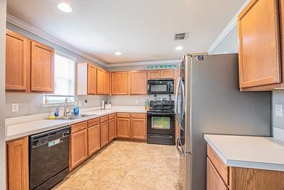 kitchen featuring black appliances, sink, and crown molding