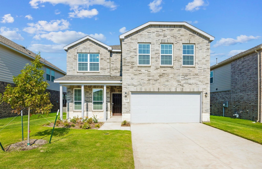 view of front of house featuring a garage and a front lawn