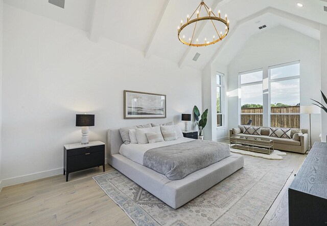 unfurnished living room with high vaulted ceiling, beamed ceiling, light hardwood / wood-style flooring, and a notable chandelier