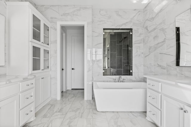 bathroom with tile walls, vanity, and shower with separate bathtub