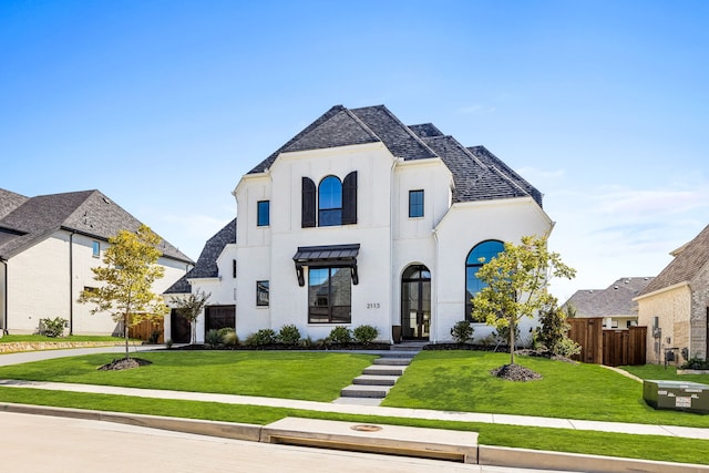 french country home featuring a front lawn