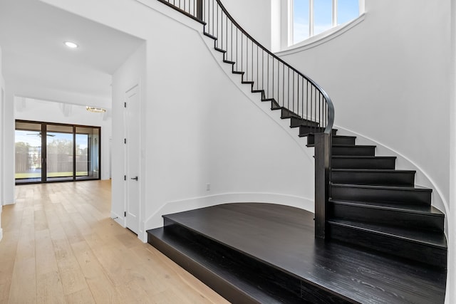 stairs featuring hardwood / wood-style floors