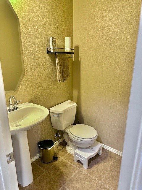 bathroom with tile patterned flooring and toilet