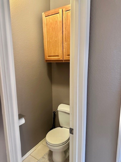 bathroom with toilet and tile patterned floors