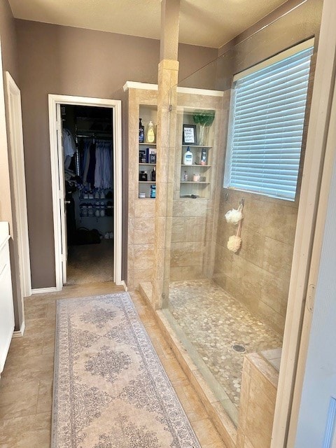 bathroom featuring a tile shower and vanity