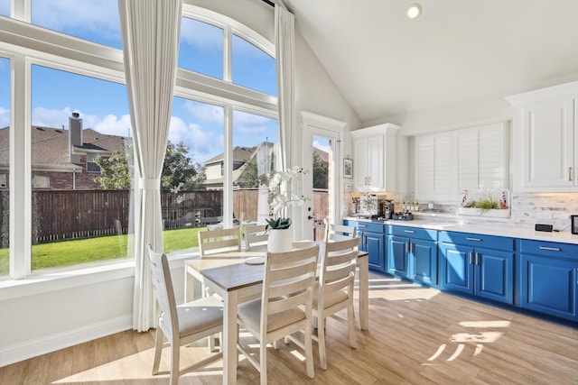 sunroom with a wealth of natural light and lofted ceiling