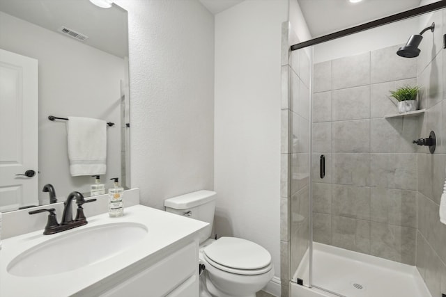 bathroom featuring vanity, toilet, and an enclosed shower