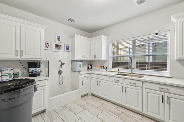 kitchen featuring white cabinets and sink