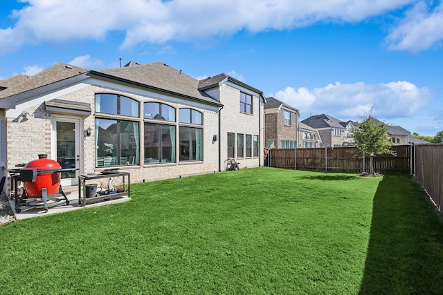 back of house with a lawn and a patio area