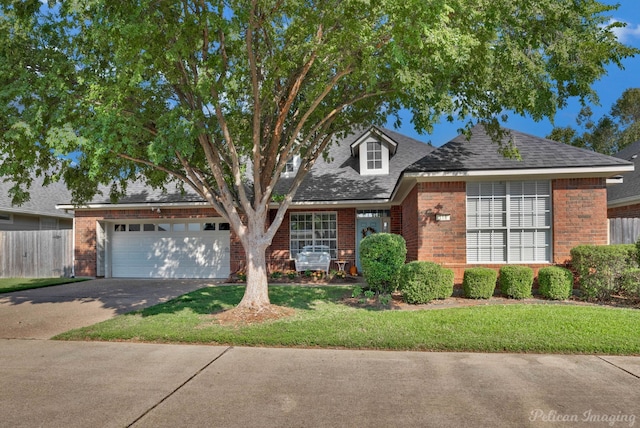 view of front facade featuring a front yard and a garage