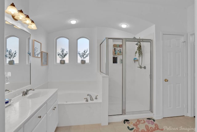 bathroom featuring vanity, lofted ceiling, shower with separate bathtub, and tile patterned flooring