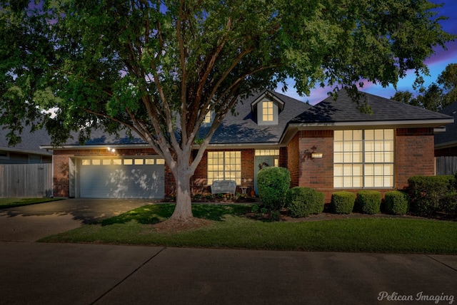 view of front of property with a lawn and a garage