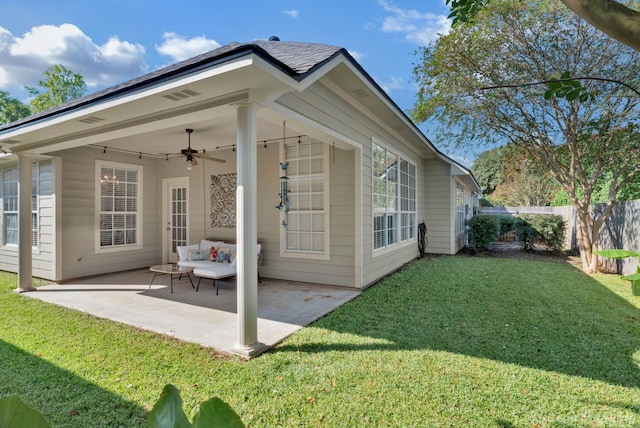 back of property featuring a patio, a yard, and ceiling fan