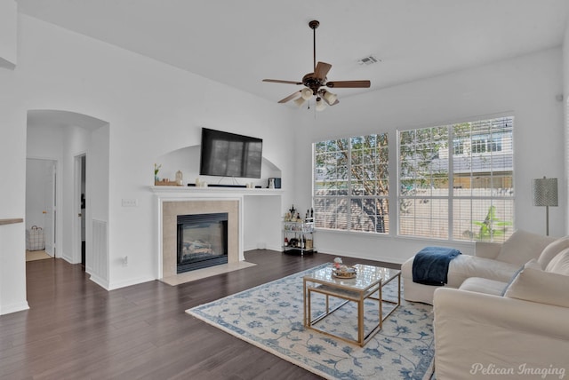 living room featuring a fireplace, dark hardwood / wood-style flooring, and ceiling fan