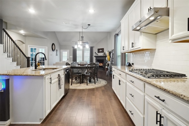 kitchen featuring an island with sink, white cabinets, ventilation hood, sink, and dark hardwood / wood-style flooring