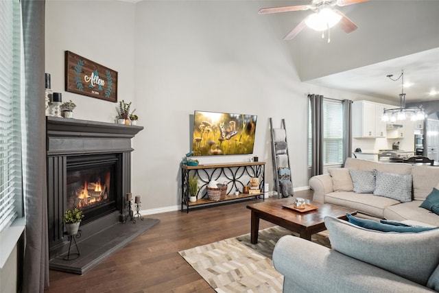 living room with ceiling fan and dark wood-type flooring