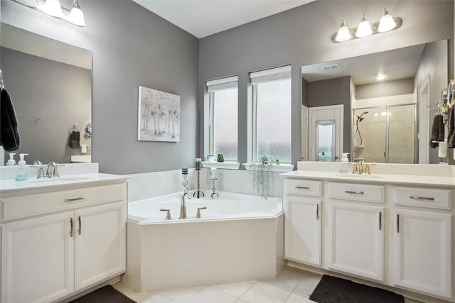 bathroom featuring tile patterned flooring, separate shower and tub, and vanity