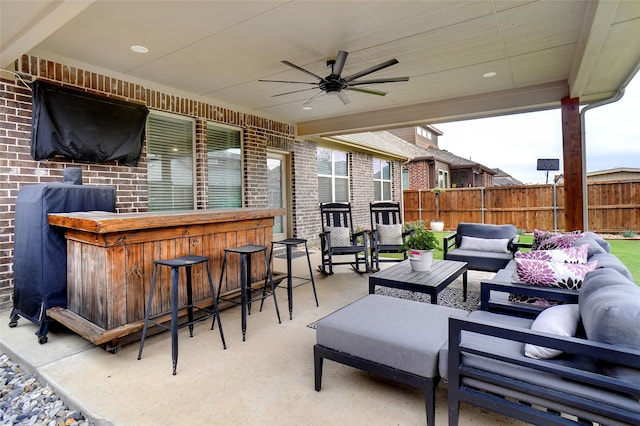 view of patio / terrace featuring ceiling fan, exterior bar, and an outdoor living space