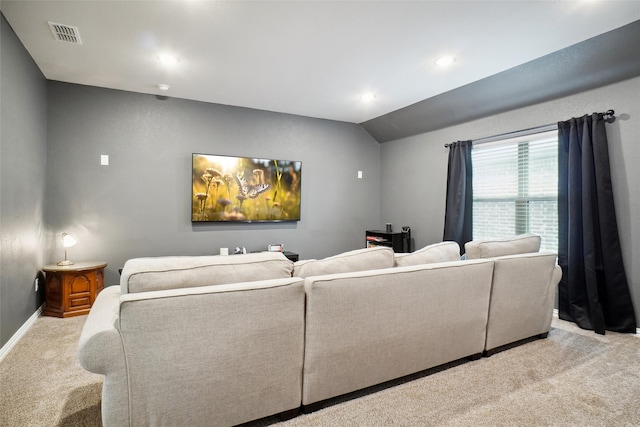 carpeted home theater room featuring lofted ceiling