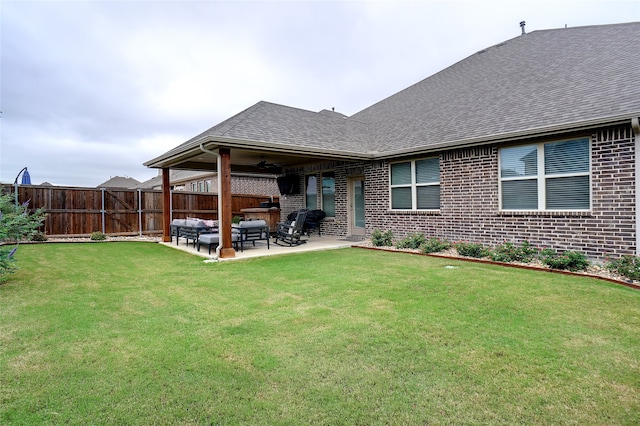 back of house featuring a patio, a lawn, and ceiling fan