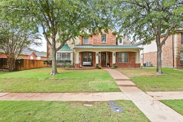 view of front facade with central air condition unit, a front yard, and a porch