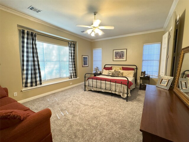 carpeted bedroom featuring crown molding and ceiling fan