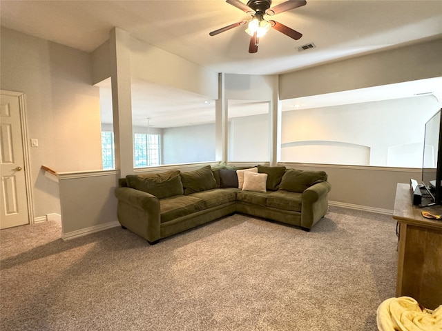 carpeted living room with ceiling fan