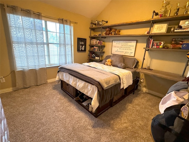 bedroom with lofted ceiling and carpet flooring