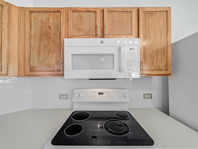 kitchen featuring black range oven and light stone countertops