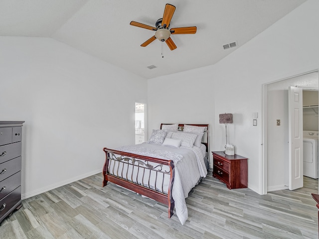 bedroom with light hardwood / wood-style floors, washer / clothes dryer, lofted ceiling, and ceiling fan