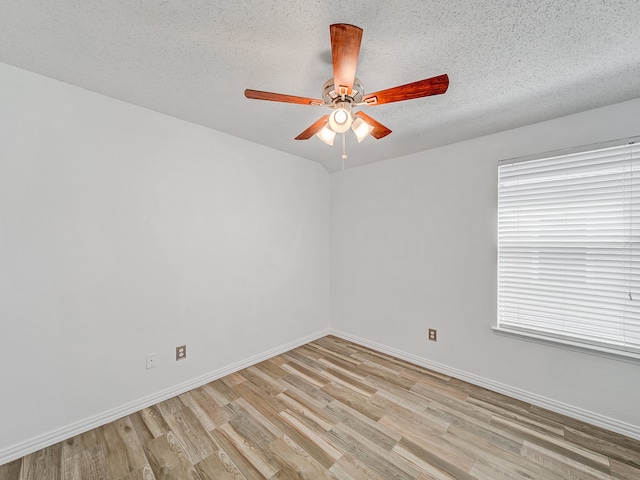 unfurnished room with a textured ceiling, ceiling fan, and light hardwood / wood-style flooring