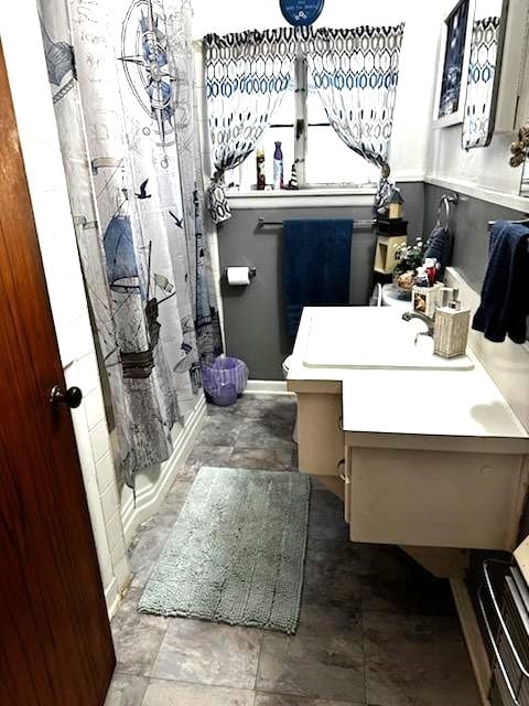 bathroom with vanity and a shower with shower curtain