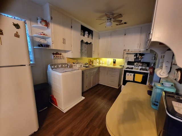 kitchen with white appliances, white cabinets, washer / dryer, dark hardwood / wood-style flooring, and ceiling fan