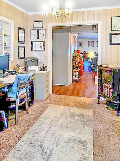 office area with built in features, ornamental molding, and a notable chandelier